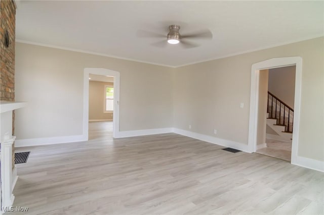 207 W Main St, Saint Clairsville, OH 43950 - unfurnished living room with a ceiling fan, light wood-type flooring, crown molding, stairway, and baseboards
