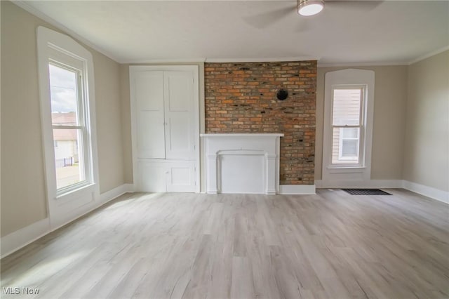 207 W Main St, Saint Clairsville, OH 43950 - unfurnished living room with baseboards, light wood-style floors, ceiling fan, crown molding, and a fireplace