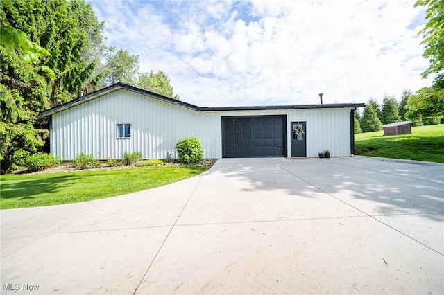 9012 Winesburg Rd, Dundee, OH 44624 - view of front of house with a front lawn, driveway, and an attached garage