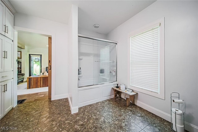 9012 Winesburg Rd, Dundee, OH 44624 - ensuite bathroom featuring bath / shower combo with glass door and baseboards