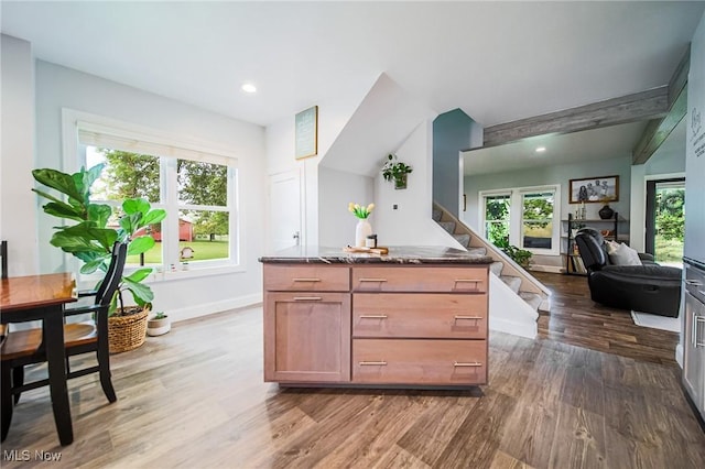9012 Winesburg Rd, Dundee, OH 44624 - kitchen with wood finished floors, healthy amount of natural light, dark stone counters, recessed lighting, and open floor plan