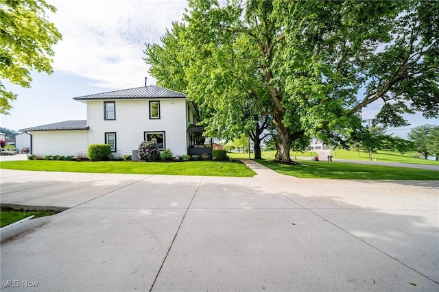 9012 Winesburg Rd, Dundee, OH 44624 - view of front of property with a standing seam roof, a front lawn, and metal roof