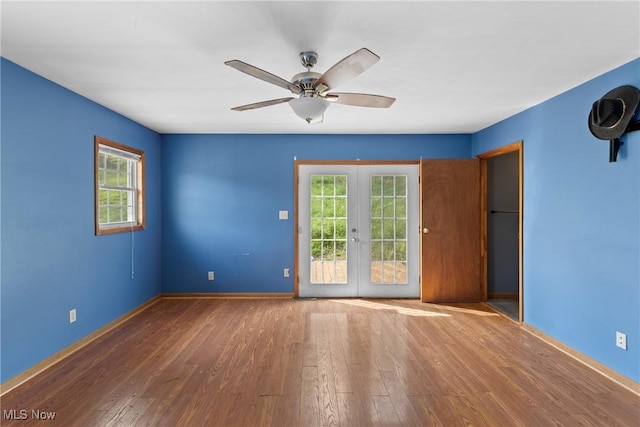 68290 Orchard Ave, Bridgeport, OH 43912 - empty room with plenty of natural light, wood finished floors, french doors, and ceiling fan
