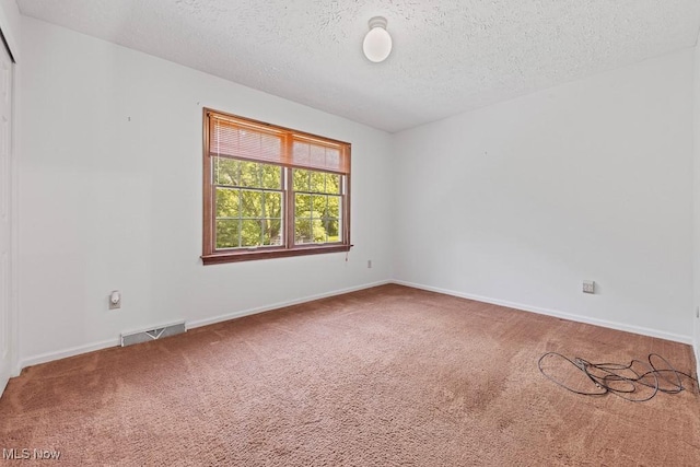 12935 Robinwood St NE, Alliance, OH 44601 - carpeted spare room featuring a textured ceiling and baseboards