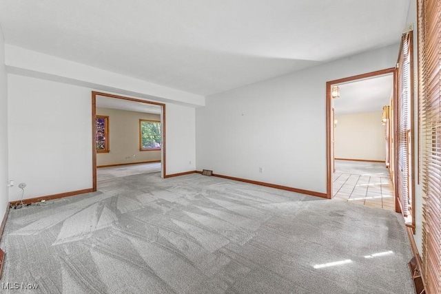 12935 Robinwood St NE, Alliance, OH 44601 - spare room featuring light colored carpet and baseboards