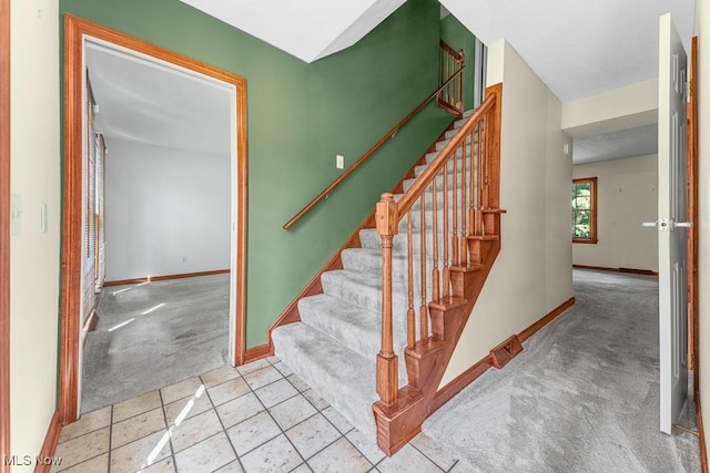 12935 Robinwood St NE, Alliance, OH 44601 - stairs featuring carpet, baseboards, and tile patterned floors