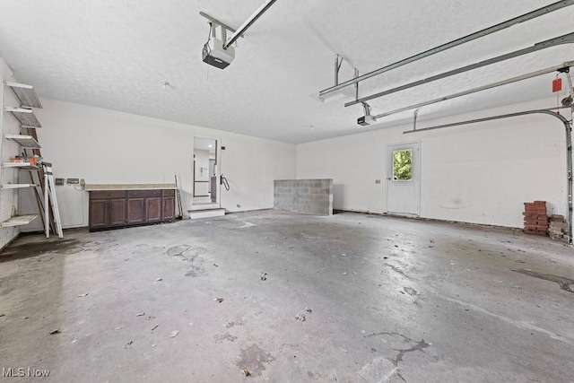 12935 Robinwood St NE, Alliance, OH 44601 - garage featuring a garage door opener
