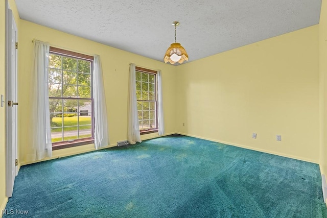 12935 Robinwood St NE, Alliance, OH 44601 - empty room featuring carpet, a textured ceiling, and baseboards