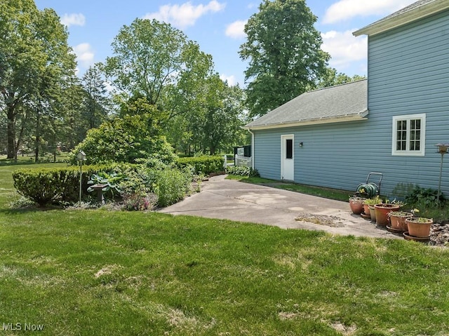 12935 Robinwood St NE, Alliance, OH 44601 - view of grassy yard with a patio