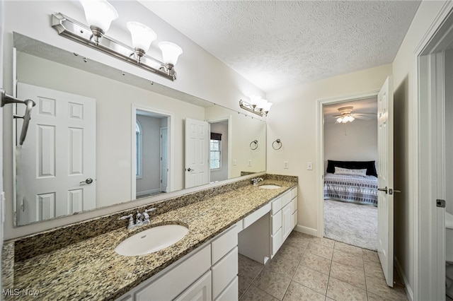 7776 Keystone Dr, Concord, OH 44077 - full bathroom featuring double vanity, connected bathroom, tile patterned floors, baseboards, and a textured ceiling