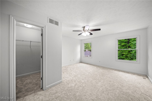 7776 Keystone Dr, Concord, OH 44077 - unfurnished bedroom featuring a spacious closet, carpet floors, a closet, baseboards, and a textured ceiling