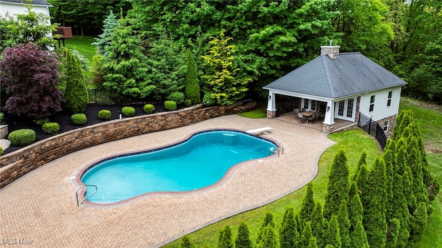 7776 Keystone Dr, Concord, OH 44077 - swimming pool with a patio, an outbuilding, a storage structure, french doors, and a diving board