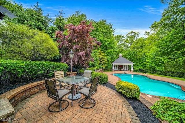 7776 Keystone Dr, Concord, OH 44077 - swimming pool featuring a storage structure, a patio, an outdoor structure, and outdoor dining area
