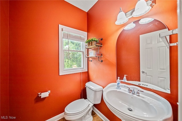 7776 Keystone Dr, Concord, OH 44077 - half bathroom with a sink, toilet, and baseboards
