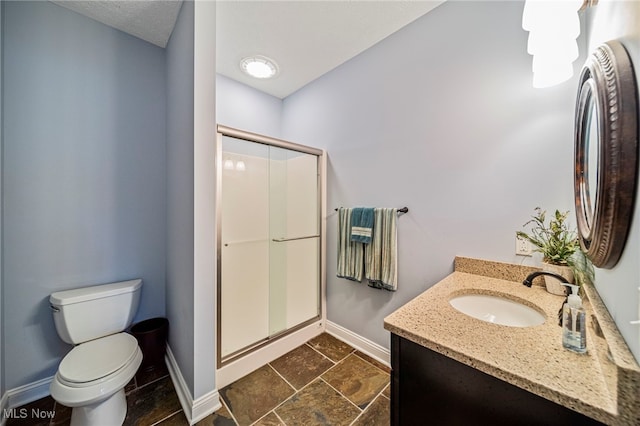 7776 Keystone Dr, Concord, OH 44077 - full bathroom with baseboards, a stall shower, toilet, vanity, and stone finish floors