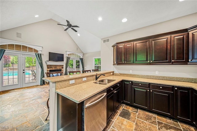 7776 Keystone Dr, Concord, OH 44077 - kitchen with dishwasher, a sink, stone tile floors, high vaulted ceiling, and french doors