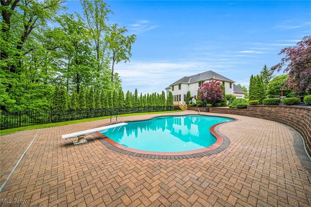 7776 Keystone Dr, Concord, OH 44077 - view of pool featuring a diving board and a patio area