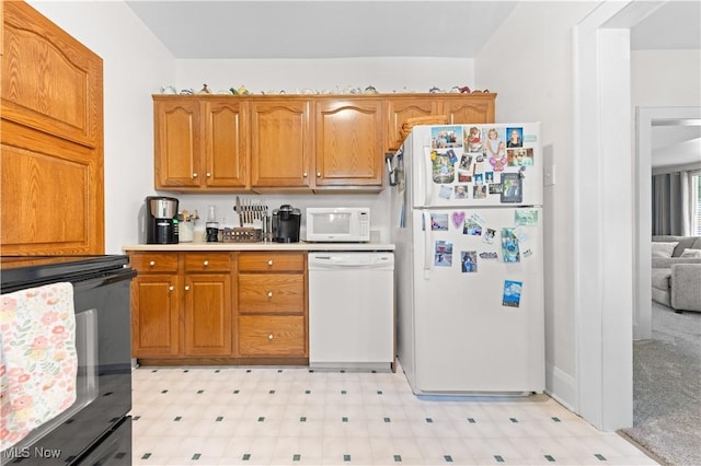 226 N 19th St, Sebring, OH 44672 - kitchen featuring white appliances, light floors, brown cabinetry, and light countertops