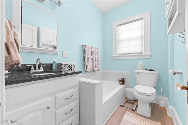 226 N 19th St, Sebring, OH 44672 - full bathroom featuring a bath, vanity, wood finished floors, and toilet