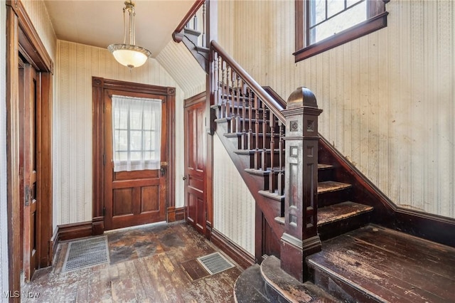 604 E Lincoln Way, Lisbon, OH 44432 - foyer with dark wood-style flooring, wallpapered walls, stairway, and baseboards
