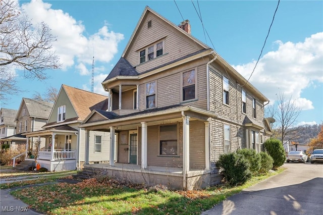604 E Lincoln Way, Lisbon, OH 44432 - view of front facade featuring covered porch and a chimney