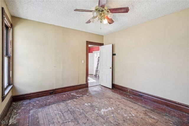 604 E Lincoln Way, Lisbon, OH 44432 - empty room featuring wood-type flooring, a ceiling fan, a textured ceiling, and baseboards
