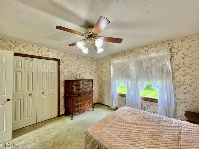 33939 Hanover Woods Trl, Solon, OH 44139 - bedroom featuring light colored carpet, wallpapered walls, ceiling fan, a closet, and a textured ceiling