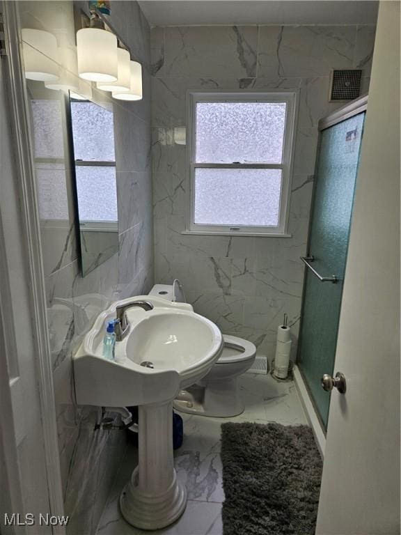 5102 Andrus Ave, North Olmsted, OH 44070 - full bathroom featuring marble finish floors, a shower stall, and toilet