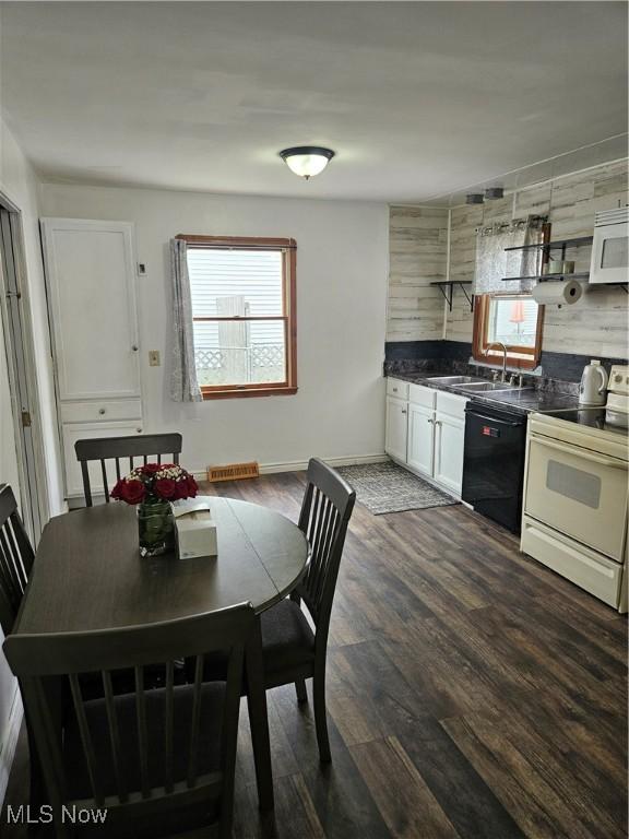 5102 Andrus Ave, North Olmsted, OH 44070 - dining room featuring dark wood finished floors and baseboards