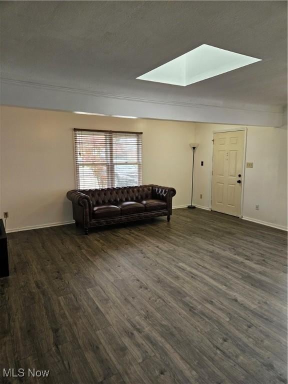 5102 Andrus Ave, North Olmsted, OH 44070 - living room featuring a skylight, dark wood-style flooring, baseboards, and crown molding