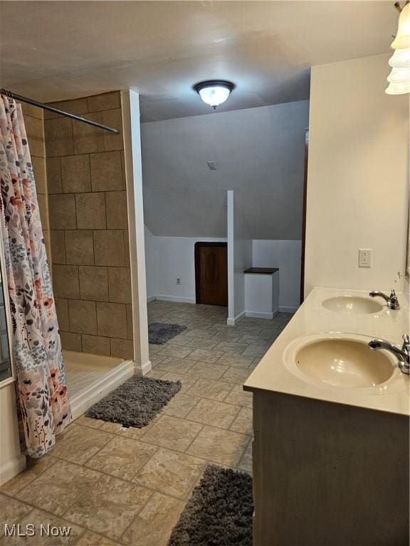 5102 Andrus Ave, North Olmsted, OH 44070 - full bathroom with a shower stall, stone finish flooring, baseboards, and double vanity