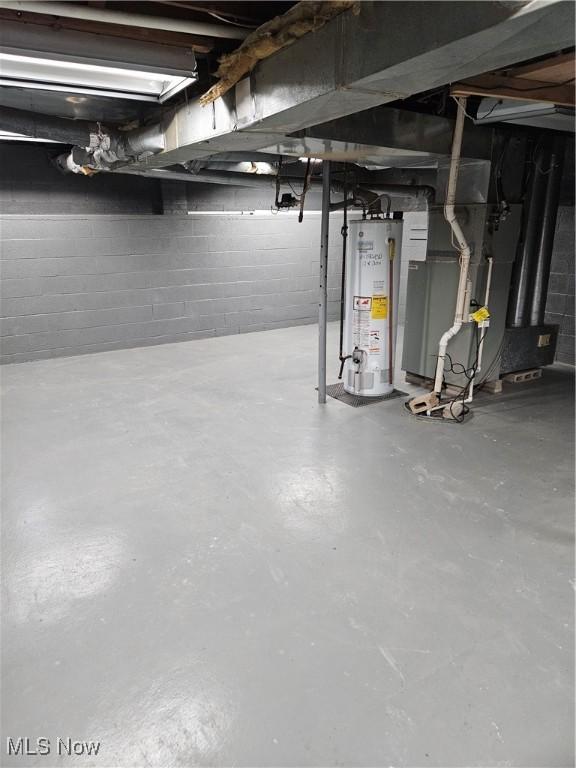 5102 Andrus Ave, North Olmsted, OH 44070 - unfinished basement with gas water heater, heating unit, and concrete block wall