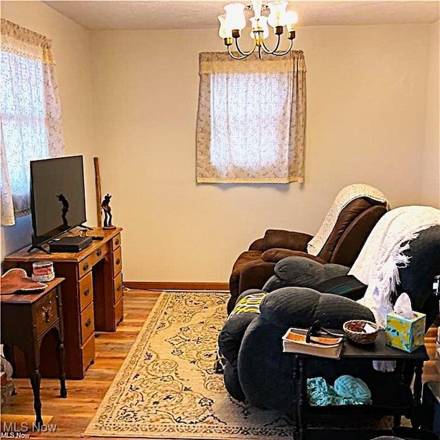 71276 Old Twenty One St, Kimbolton, OH 43725 - living area featuring a chandelier, light wood-type flooring, and baseboards