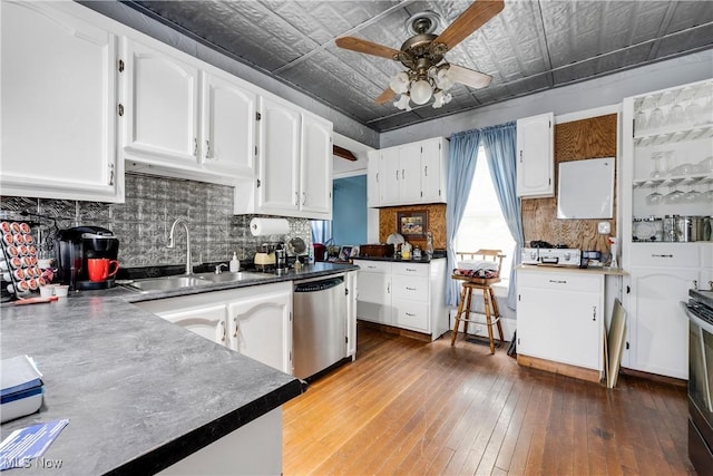 28900 Euclid Ave, Wickliffe, OH 44092 - kitchen with stainless steel dishwasher, a sink, an ornate ceiling, ceiling fan, and white cabinetry