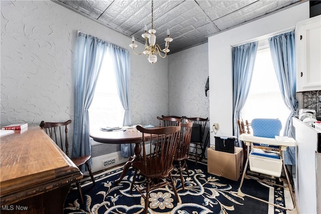 28900 Euclid Ave, Wickliffe, OH 44092 - dining space featuring a textured wall and a chandelier