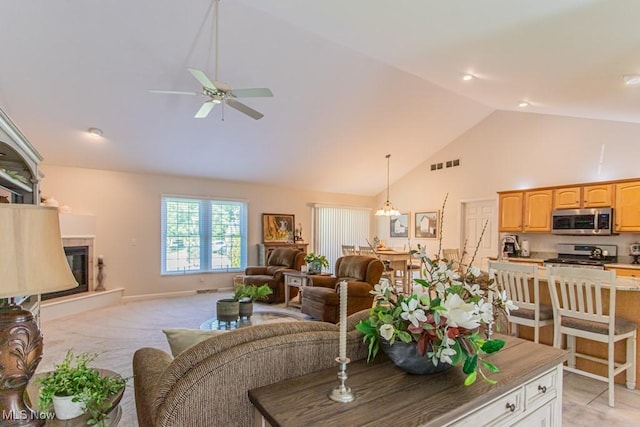 8121 Hitchcock Rd Unit 1, Youngstown, OH 44512 - living room with ceiling fan, high vaulted ceiling, a chandelier, a tiled fireplace, and light carpet