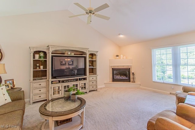 8121 Hitchcock Rd Unit 1, Youngstown, OH 44512 - carpeted living room featuring a ceiling fan, a tile fireplace, baseboards, and high vaulted ceiling