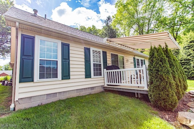 8121 Hitchcock Rd Unit 1, Youngstown, OH 44512 - view of property exterior featuring a lawn, a deck, and a shingled roof