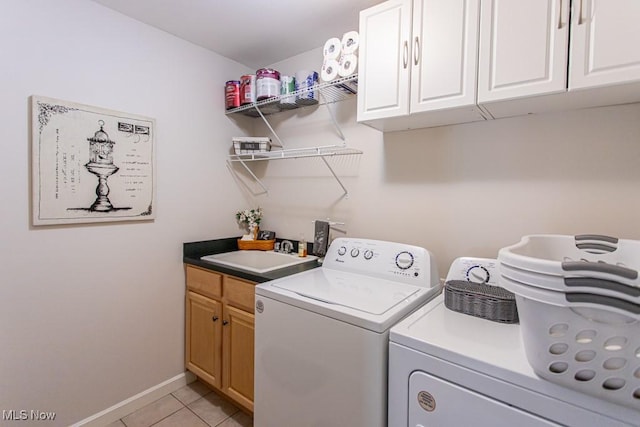 8121 Hitchcock Rd Unit 1, Youngstown, OH 44512 - washroom featuring washer and clothes dryer, cabinet space, light tile patterned flooring, and baseboards