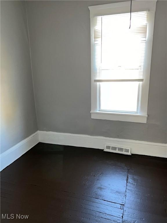 6701 Gertrude Ave, Cleveland, OH 44105 - spare room featuring baseboards, plenty of natural light, and hardwood / wood-style floors