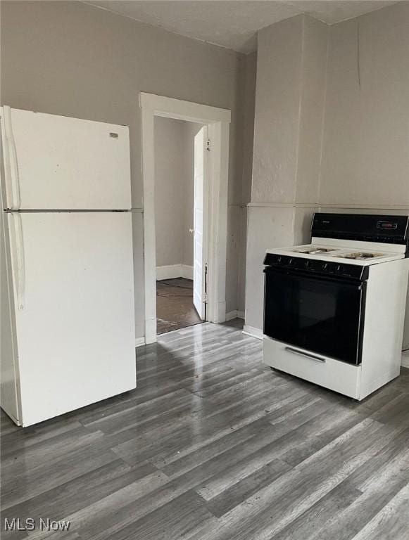 6701 Gertrude Ave, Cleveland, OH 44105 - kitchen with freestanding refrigerator, electric range oven, dark wood-style flooring, and baseboards