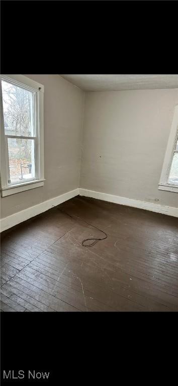 6701 Gertrude Ave, Cleveland, OH 44105 - spare room with baseboards, healthy amount of natural light, and hardwood / wood-style floors