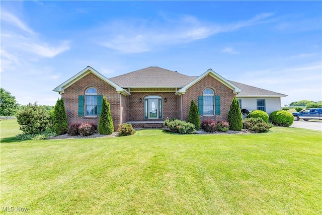 9903 Vermilion Rd, Amherst, OH 44001 - view of front facade featuring brick siding, a front lawn, and a shingled roof