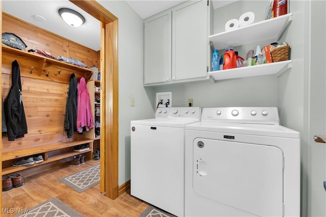 9903 Vermilion Rd, Amherst, OH 44001 - washroom featuring cabinet space, independent washer and dryer, and light wood-style floors