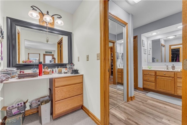 9903 Vermilion Rd, Amherst, OH 44001 - bathroom featuring vanity, wood finished floors, and baseboards
