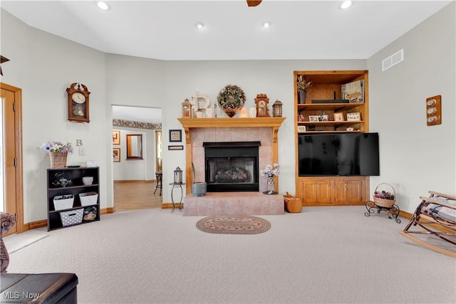 9903 Vermilion Rd, Amherst, OH 44001 - carpeted living area featuring recessed lighting, a tiled fireplace, and baseboards