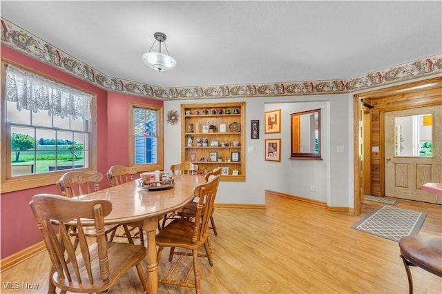 9903 Vermilion Rd, Amherst, OH 44001 - dining area featuring plenty of natural light, light wood finished floors, and baseboards