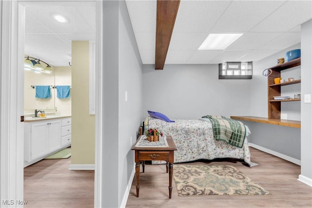 9903 Vermilion Rd, Amherst, OH 44001 - bedroom with a drop ceiling, wood finished floors, baseboards, a sink, and ensuite bath