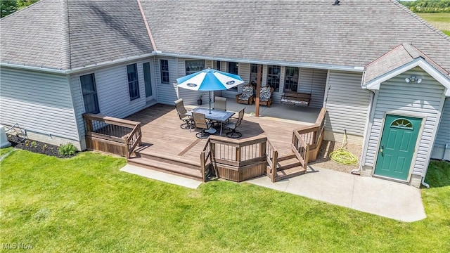 9903 Vermilion Rd, Amherst, OH 44001 - wooden deck with outdoor dining area, a lawn, and central AC