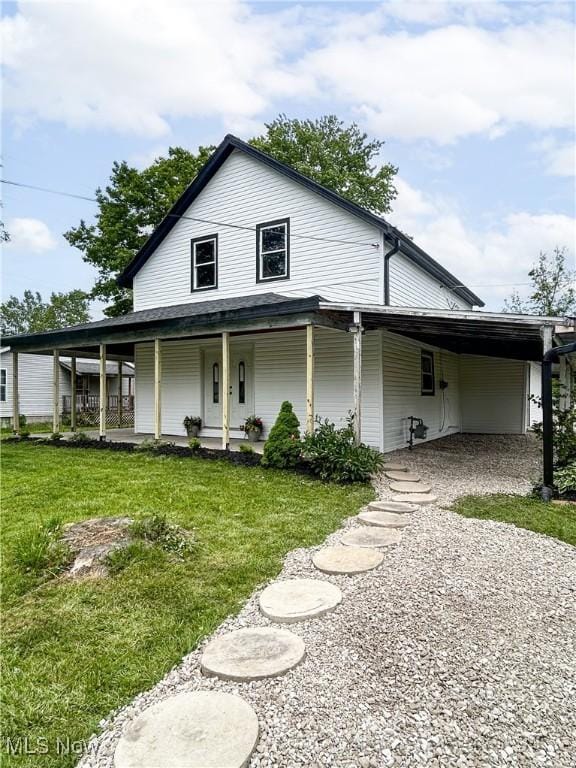 23 2nd St, West Salem, OH 44287 - country-style home featuring covered porch, a carport, a front yard, and gravel driveway